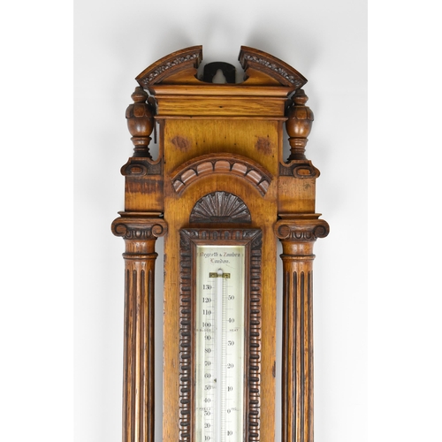 229 - A late Victorian/Edwardian Zegretti & Zambra oak cased barometer, the carved case having an open arc... 