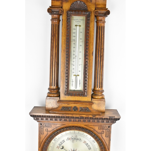 229 - A late Victorian/Edwardian Zegretti & Zambra oak cased barometer, the carved case having an open arc... 