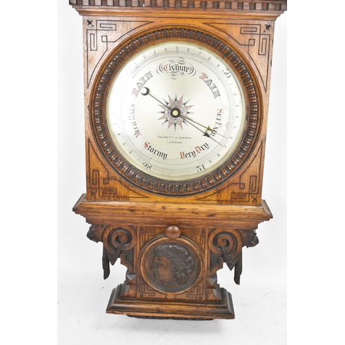 229 - A late Victorian/Edwardian Zegretti & Zambra oak cased barometer, the carved case having an open arc... 