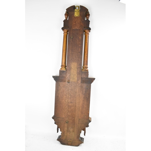 229 - A late Victorian/Edwardian Zegretti & Zambra oak cased barometer, the carved case having an open arc... 