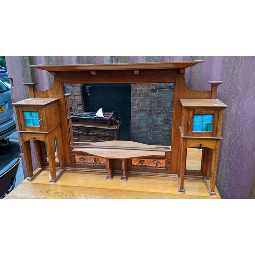 246 - An Arts & Crafts oak mirrored back sideboard, having a moulded flat top pediment above a central mir... 