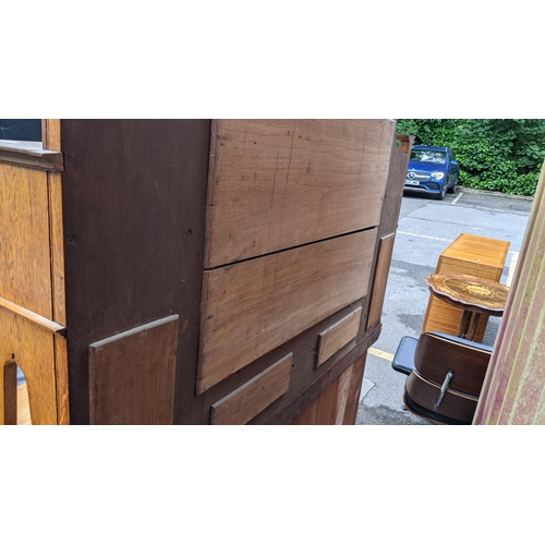 246 - An Arts & Crafts oak mirrored back sideboard, having a moulded flat top pediment above a central mir... 