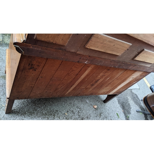 246 - An Arts & Crafts oak mirrored back sideboard, having a moulded flat top pediment above a central mir... 