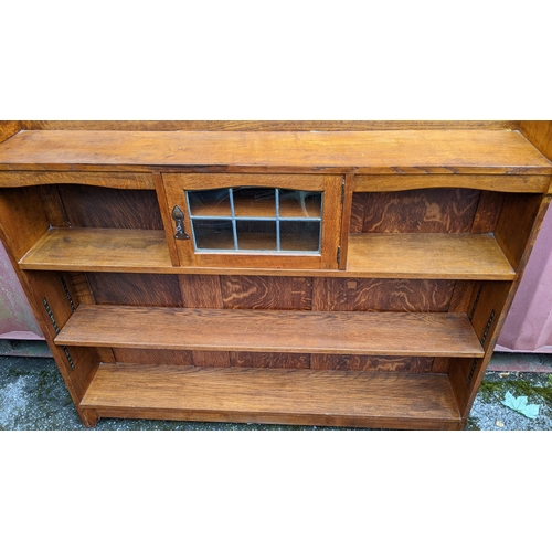 247 - A Liberty & Co oak Arts & Crafts bookcase attributed to the Cotswold Suit design, having a three qua... 