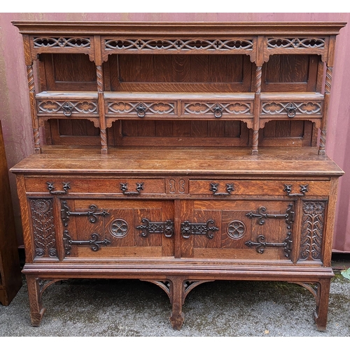 250 - An early 20th century Hampton & Sons Gothic revival oak dresser, the top having a moulded stepped co... 