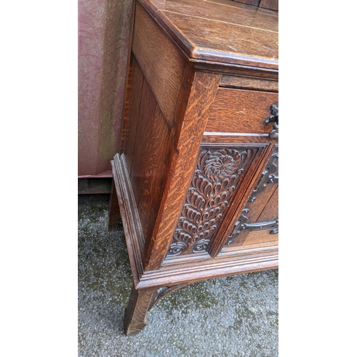 250 - An early 20th century Hampton & Sons Gothic revival oak dresser, the top having a moulded stepped co... 