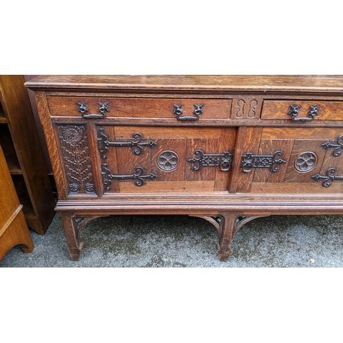 250 - An early 20th century Hampton & Sons Gothic revival oak dresser, the top having a moulded stepped co... 