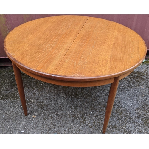 251 - Victor B Wilkins for G Plan - A retro 1960s teak 'Fresco' range extending dining table, of circular ... 