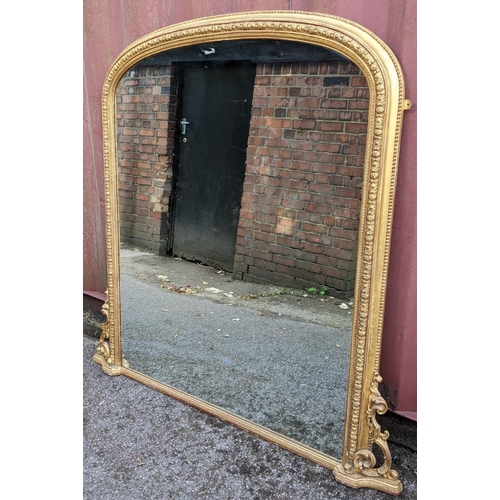 254 - A Victorian gilt wood over mantle mirror, the moulded arched topped frame having a beaded rim enclos... 