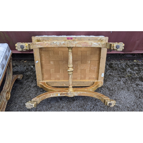 256 - A pair of 19th century gilt wood X-framed stools, each of the frames having a central motif enclosed... 