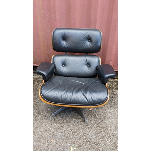 257 - A vintage black leather armchair and ottoman, after the design by Charles and Ray Eames for Herman M... 