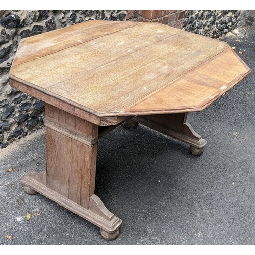 259 - A 1930s Heals style limed oak extending dining table, having an octagonal top with two fall flaps hi... 