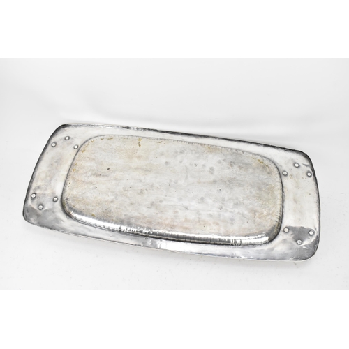 26 - An Arts & Crafts silver plated twin handled tray, possibly by liberty, of rectangular form, the rais... 