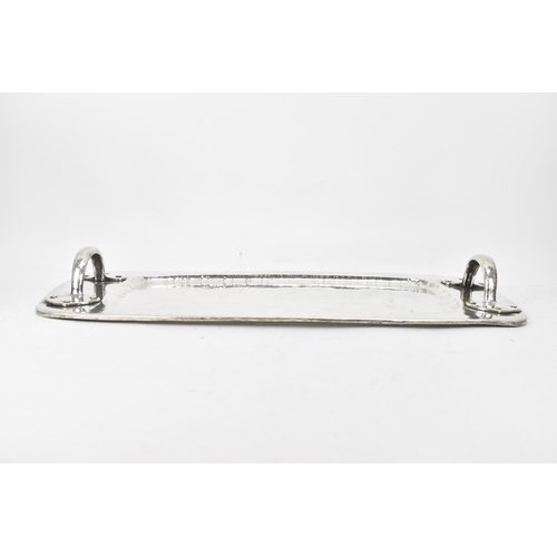 26 - An Arts & Crafts silver plated twin handled tray, possibly by liberty, of rectangular form, the rais... 