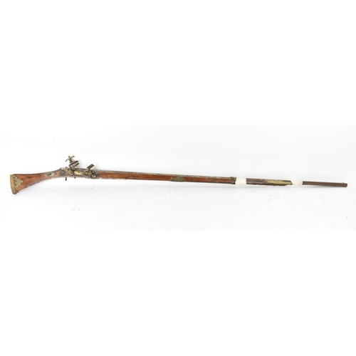 261 - A 19th century Middle Eastern flintlock action Jezail rifle, the barrel engraved with scroll design,... 