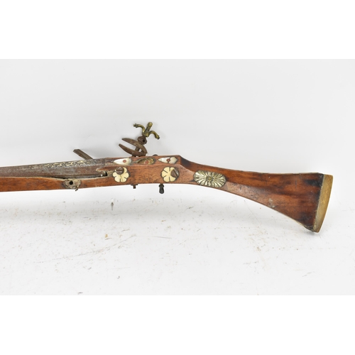 261 - A 19th century Middle Eastern flintlock action Jezail rifle, the barrel engraved with scroll design,... 