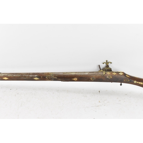 262 - A 19th century Middle Eastern flintlock action Jezail rifle, octagonal formed barrel, the stock inla... 