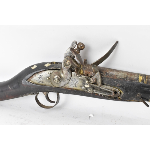 263 - A 19th century Middle Eastern flintlock action Jezail rifle, the barrel engraved with scroll design,... 