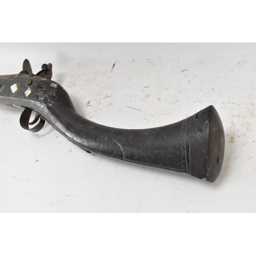 263 - A 19th century Middle Eastern flintlock action Jezail rifle, the barrel engraved with scroll design,... 