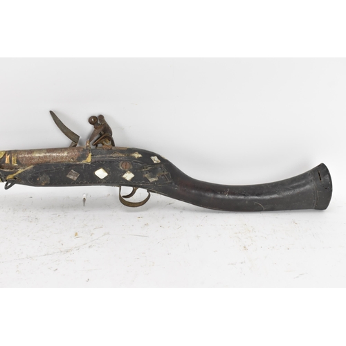 263 - A 19th century Middle Eastern flintlock action Jezail rifle, the barrel engraved with scroll design,... 