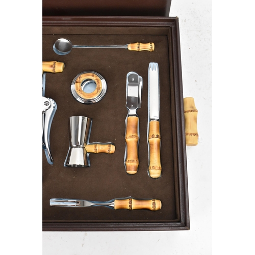 269 - A Lorenzi Milano Italian brown leather cased bar set, comprising a double lever corkscrew, cap lifte... 