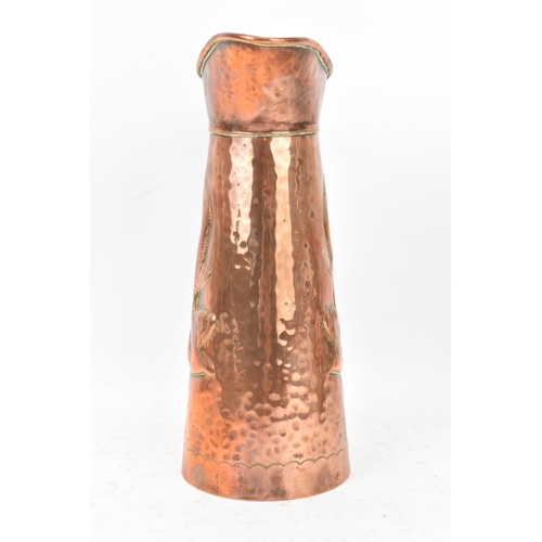 38 - A Newlyn Arts & Crafts copper jug of cylindrical tapering design with embossed fish decoration, rive... 