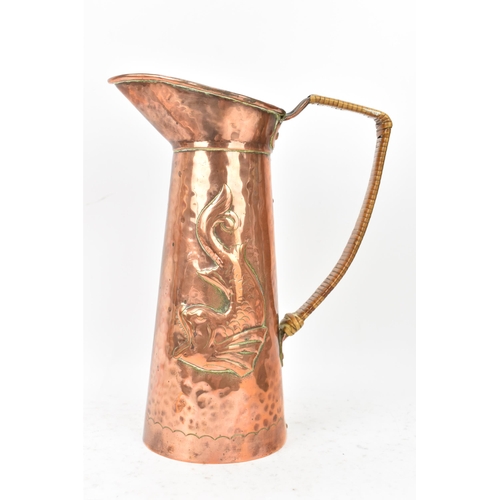 38 - A Newlyn Arts & Crafts copper jug of cylindrical tapering design with embossed fish decoration, rive... 