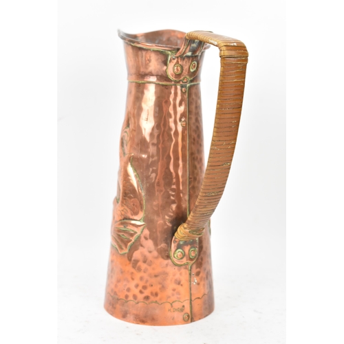 38 - A Newlyn Arts & Crafts copper jug of cylindrical tapering design with embossed fish decoration, rive... 