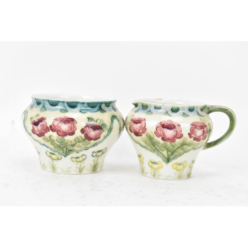 40 - A William Moorcroft (1872-1945) for James Macintyre & Co 'Rose and Poppy' three piece tea set with a... 