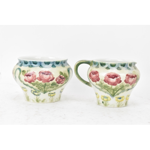 40 - A William Moorcroft (1872-1945) for James Macintyre & Co 'Rose and Poppy' three piece tea set with a... 