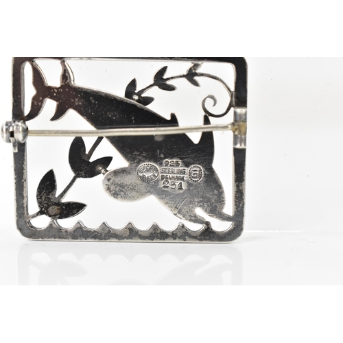 67 - A Georg Jensen silver twin dolphin brooch, design no. 251, the rectangular frame with a pair of leap... 