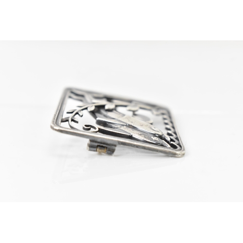 67 - A Georg Jensen silver twin dolphin brooch, design no. 251, the rectangular frame with a pair of leap... 