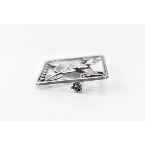 67 - A Georg Jensen silver twin dolphin brooch, design no. 251, the rectangular frame with a pair of leap... 