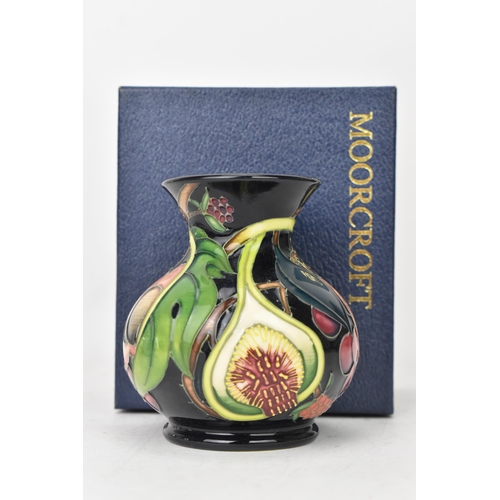 70 - A Moorcroft pottery 'Queens Choice pattern' vase, of baluster form, underglaze painted and tube-line... 