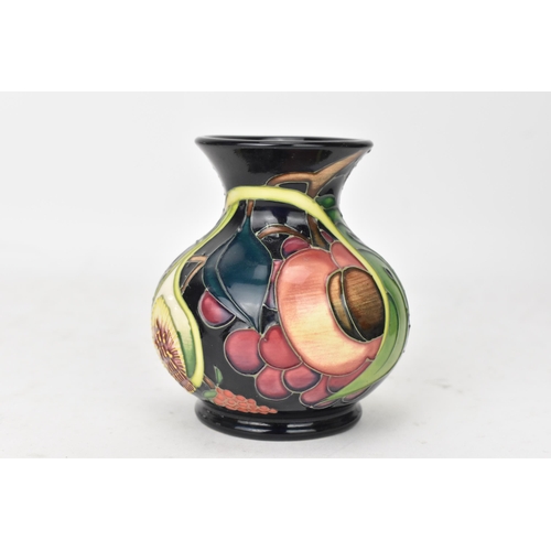 70 - A Moorcroft pottery 'Queens Choice pattern' vase, of baluster form, underglaze painted and tube-line... 