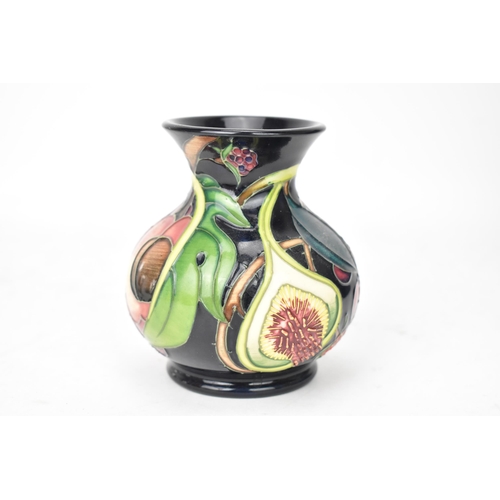 70 - A Moorcroft pottery 'Queens Choice pattern' vase, of baluster form, underglaze painted and tube-line... 