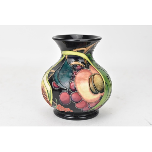 70 - A Moorcroft pottery 'Queens Choice pattern' vase, of baluster form, underglaze painted and tube-line... 