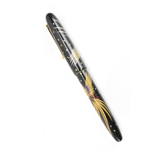 72 - A Namiki ballpoint pen, in black lacquer and relief decorated depicting phoenix birds in flight, cha... 