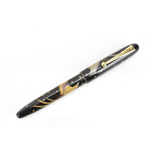 72 - A Namiki ballpoint pen, in black lacquer and relief decorated depicting phoenix birds in flight, cha... 