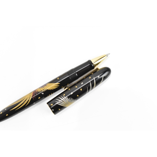 72 - A Namiki ballpoint pen, in black lacquer and relief decorated depicting phoenix birds in flight, cha... 