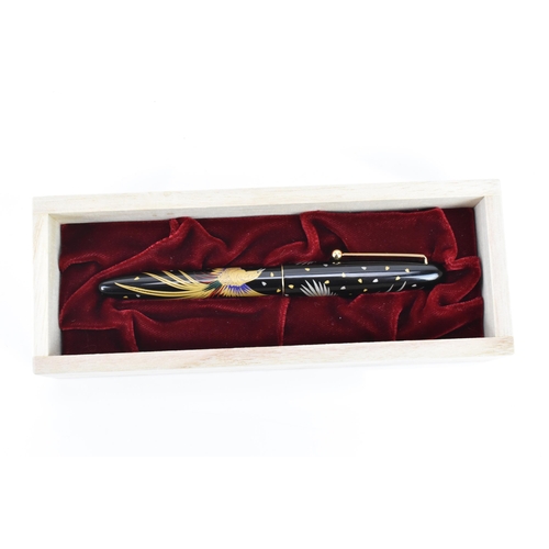 72 - A Namiki ballpoint pen, in black lacquer and relief decorated depicting phoenix birds in flight, cha... 