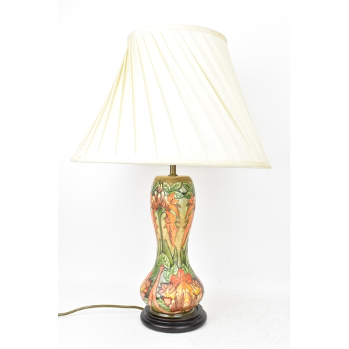 78 - A Moorcroft pottery 'Flame Of The Forest' pattern table lamp, of baluster form, tube lined with flow... 