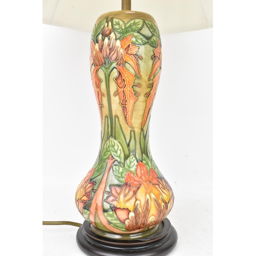 78 - A Moorcroft pottery 'Flame Of The Forest' pattern table lamp, of baluster form, tube lined with flow... 