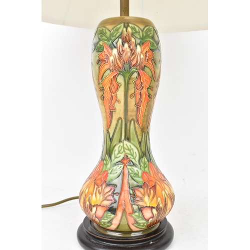 78 - A Moorcroft pottery 'Flame Of The Forest' pattern table lamp, of baluster form, tube lined with flow... 