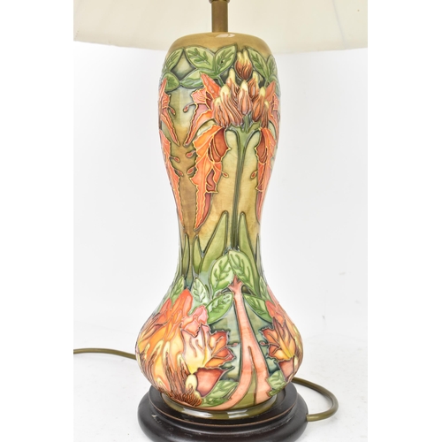 78 - A Moorcroft pottery 'Flame Of The Forest' pattern table lamp, of baluster form, tube lined with flow... 