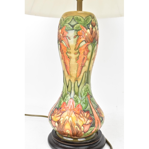 78 - A Moorcroft pottery 'Flame Of The Forest' pattern table lamp, of baluster form, tube lined with flow... 