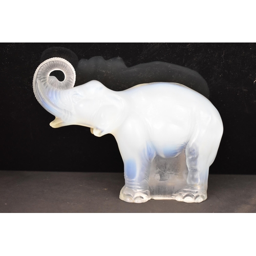 84 - Attributed to James A. Jobling & Co - An Art Deco opalescent glass moulded model of an elephant, sta... 