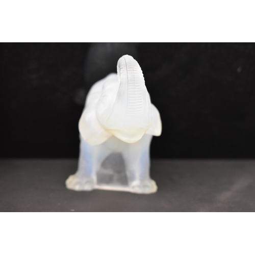 84 - Attributed to James A. Jobling & Co - An Art Deco opalescent glass moulded model of an elephant, sta... 