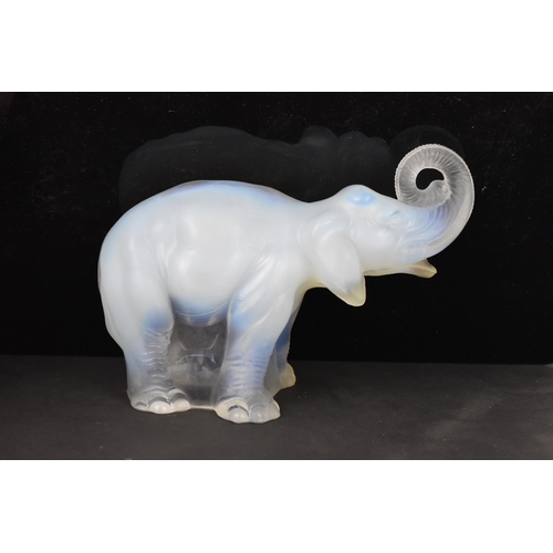 84 - Attributed to James A. Jobling & Co - An Art Deco opalescent glass moulded model of an elephant, sta... 