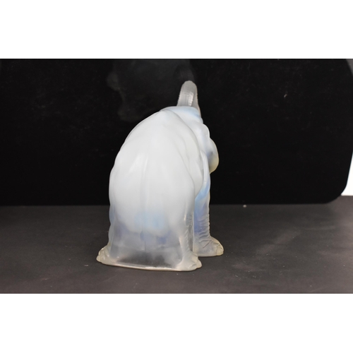 84 - Attributed to James A. Jobling & Co - An Art Deco opalescent glass moulded model of an elephant, sta... 